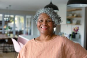 Smiling senior woman contemplating costs of life care community