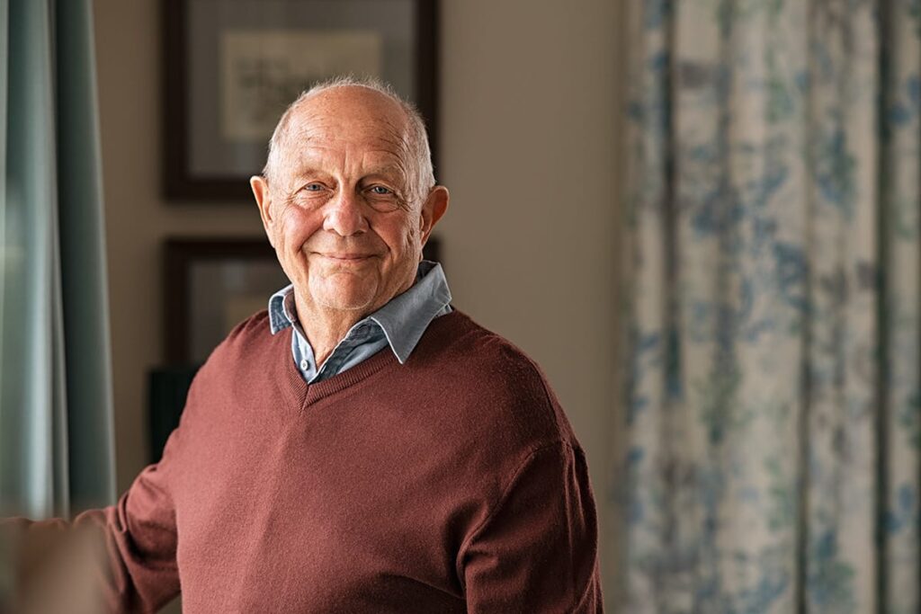 man smiling in senior community while enjoying ccrc benefits for couples