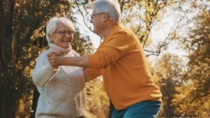 bigstock-Happy-Old-Couple-Dancing-In-Pa-390519233-1