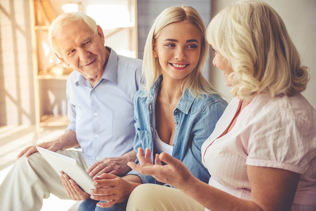 granddaughter helping her grandparents with touring senior apartments