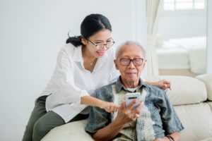 father and daughter looking at assisted living safety procedures