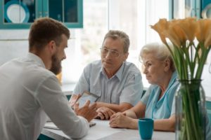 older couple discussing independent vs assisted living at a senior living community