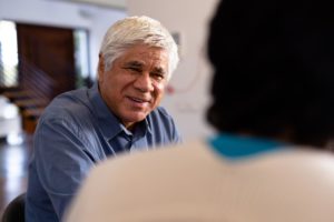 man talking with person about senior mental health