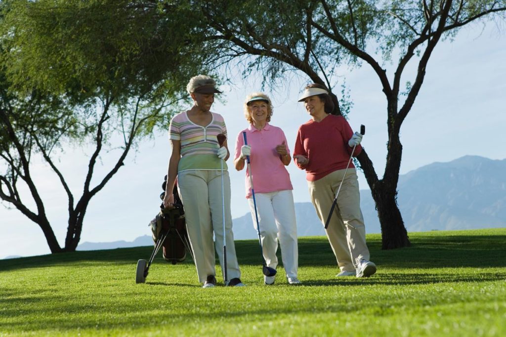 women on the golf course staying active in retirement
