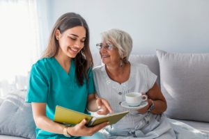 woman talking with older adult holding teacup about long term care for seniors