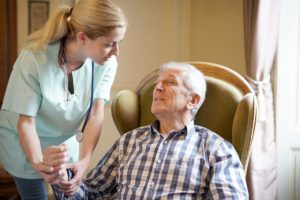 Man and caregiver in a long-term memory care facility