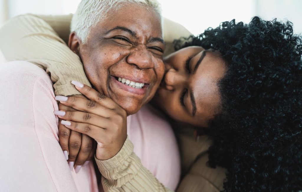 Woman showing affection and caring for an aging parent