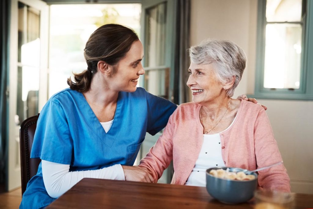 Nurse assisting a senior in recovery after a fall