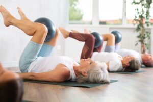 seniors on yoga mats doing balance exercises for seniors