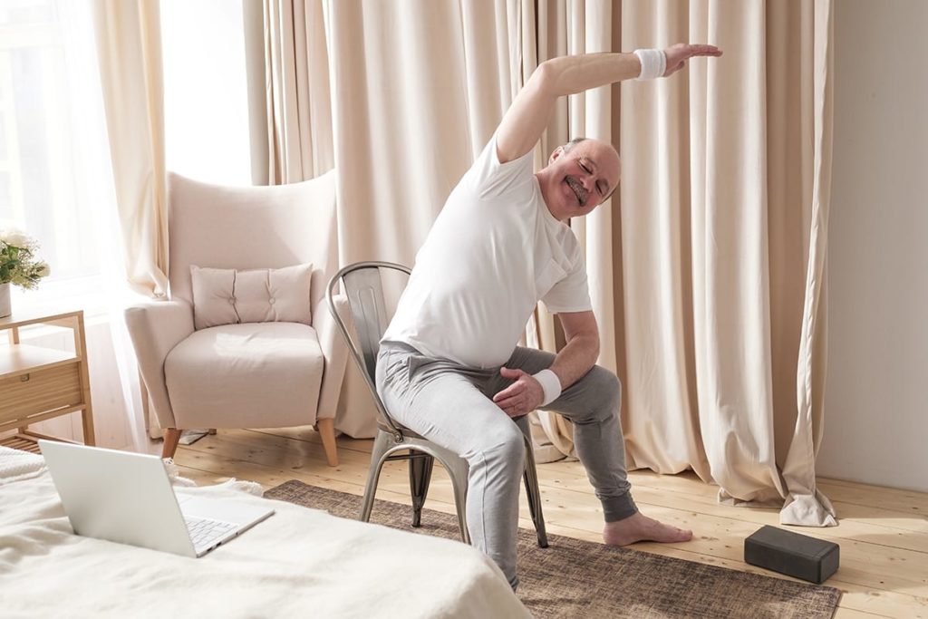 Older adult practicing chair yoga