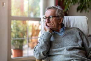 Person looking out window and recognizing in themselves signs of anxiety in seniors
