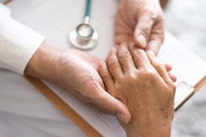 Doctor examining and comforting a senior patient during Alzheimer's and Brain Awareness Month