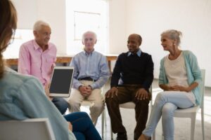 People sitting in a circle while talking about the benefits of memory care communities