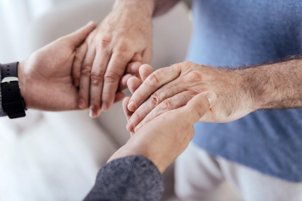 Person holding hands and caring for a relative with Alzheimers