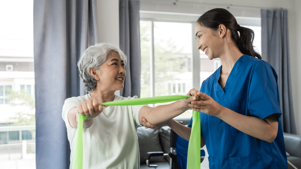 Woman using a resistance band with guidance of physical therapist in rehabilitation for seniors in dallas-fort worth