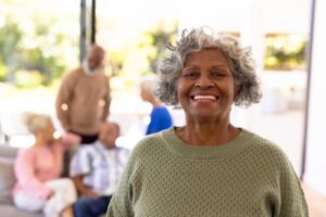 Happy person smiling while receiving senior life care services in an assisted living community 