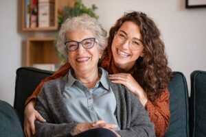 long-term care candidate and daughter smiling for a photo while in an assisted living center