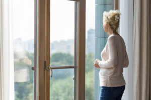 older adult enjoying gorgeous view as one of many benefits of senior luxury-high rise apartments