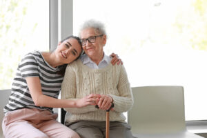 caregiver and senior woman using respite care to avoid signs of caregiver stress