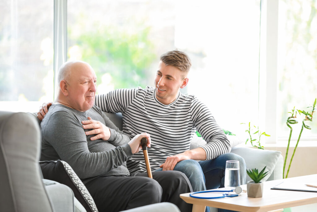 younger person and senior enjoying time together while caregiver fulfills responsibilities of caregivers